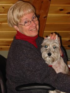 Linda Brinser and current dog Skipper working together in the office.